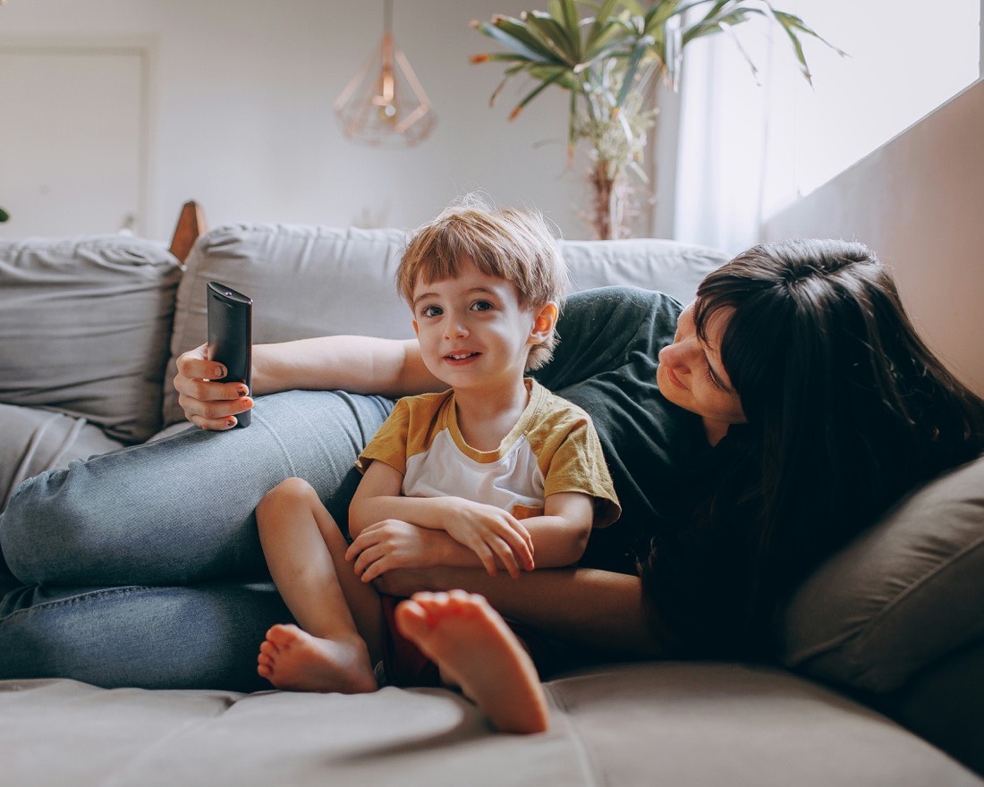 Two family members talking warmly together on the living-room couch